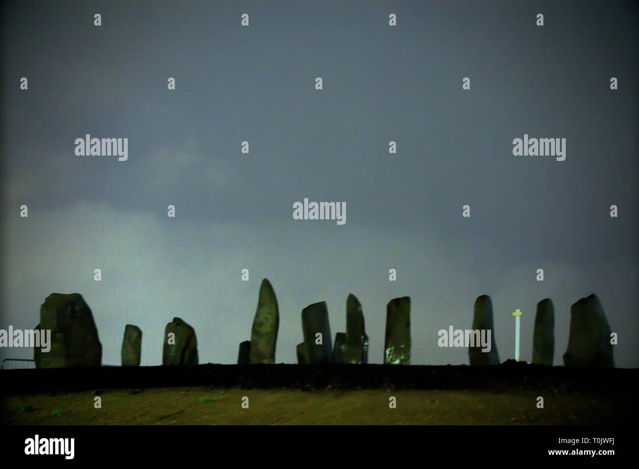 Glasgow, Scotland, UK, 20th March, 2019, UK Weather: Sighthill circle a stone circle is restored 40 years after first being built for the spring Equinox. Iy was the first new stone circle erected in the UK for 3000 years now re-erected, after being re-sited as part of the largest public housing project in Europe for the important Druidic festival. The circle was first erected in the 1980’s them moved to be an important cultural and artistic part of what is a reborn community with a 250 million pound housing budget. The solstice was tonight after dark. Credit Gerard Ferry/Alamy Live News Stock Photo