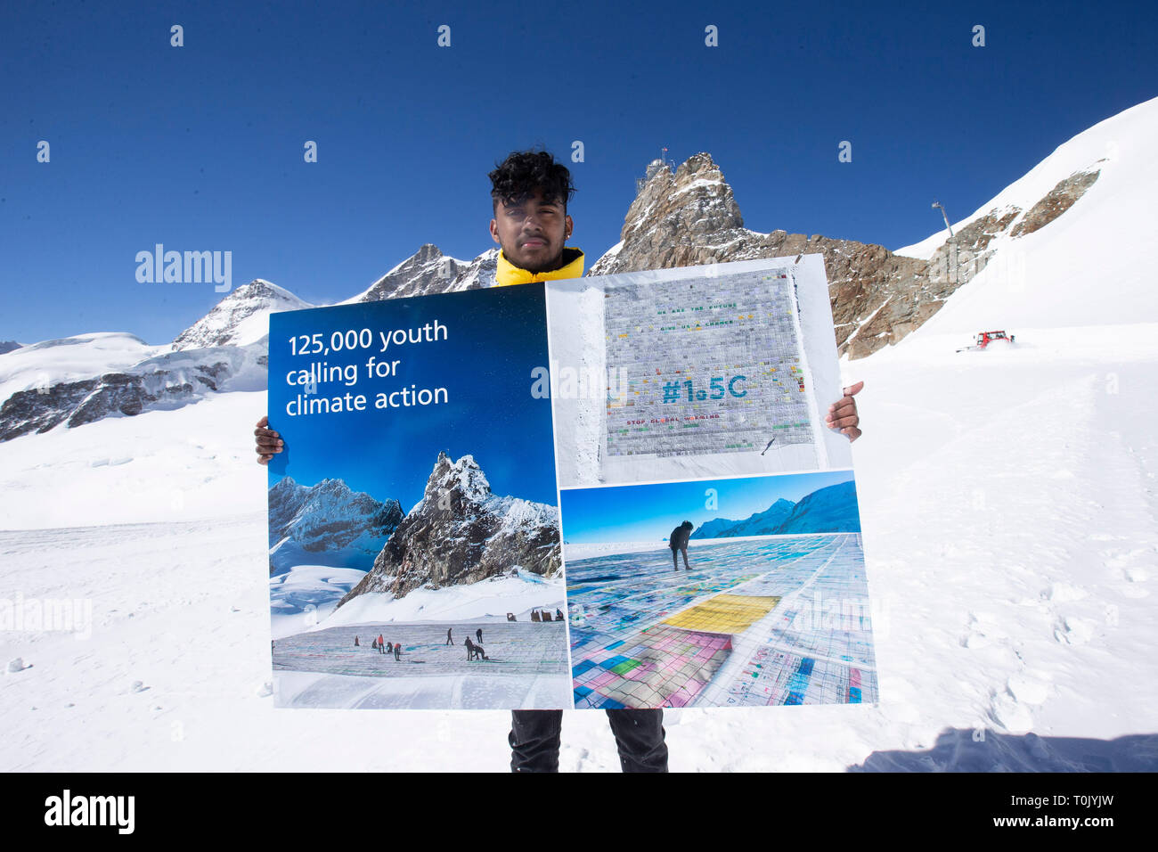 Jungfraujoch. 20th Mar, 2019. Swiss teenager Sarangan Sivarajalingam shows a copy of a postcard calling for action against climate change on the Aletsch glacier under Jungfraujoch in Switzerland, on March 20, 2019. Some 900 postcards from youths all over the world were stamped and sent on Wednesday from Europe's highest postbox on the Jungfraujoch peak, Switzerland, to global leaders, calling for action against climate change. Credit: Xu Jinquan/Xinhua/Alamy Live News Stock Photo