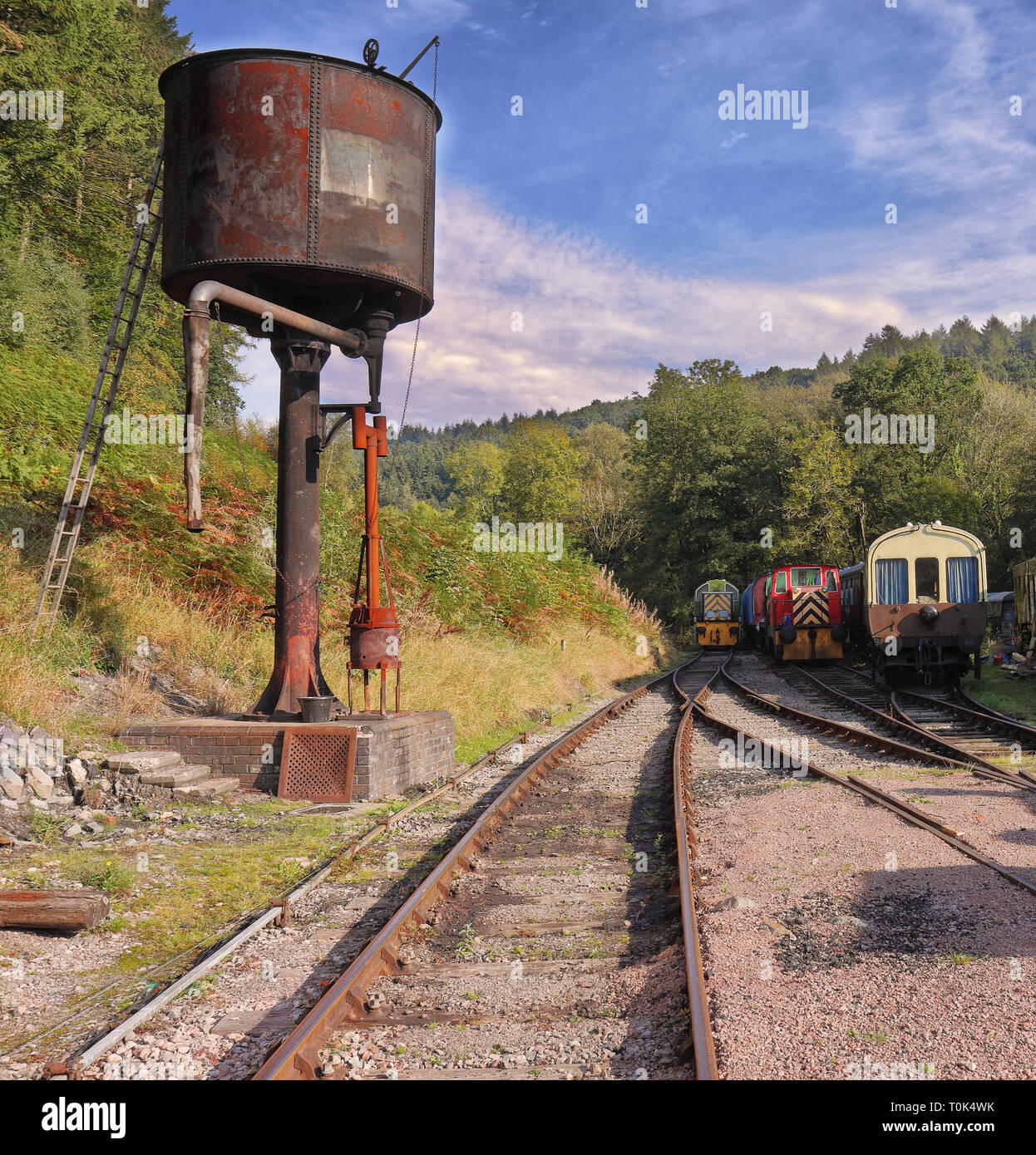 The Age of Steam, Vintage carriages and water tower on  Dean Forest Railway in Gloucestershire, England Stock Photo