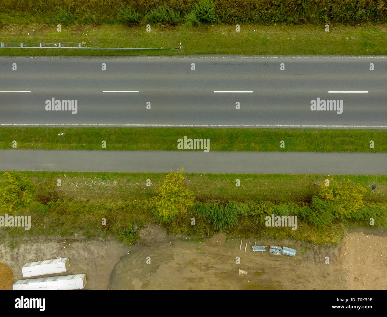 Graphic and abstract aerial view of the vertical photograph of a road with markings between fields, Germany Stock Photo