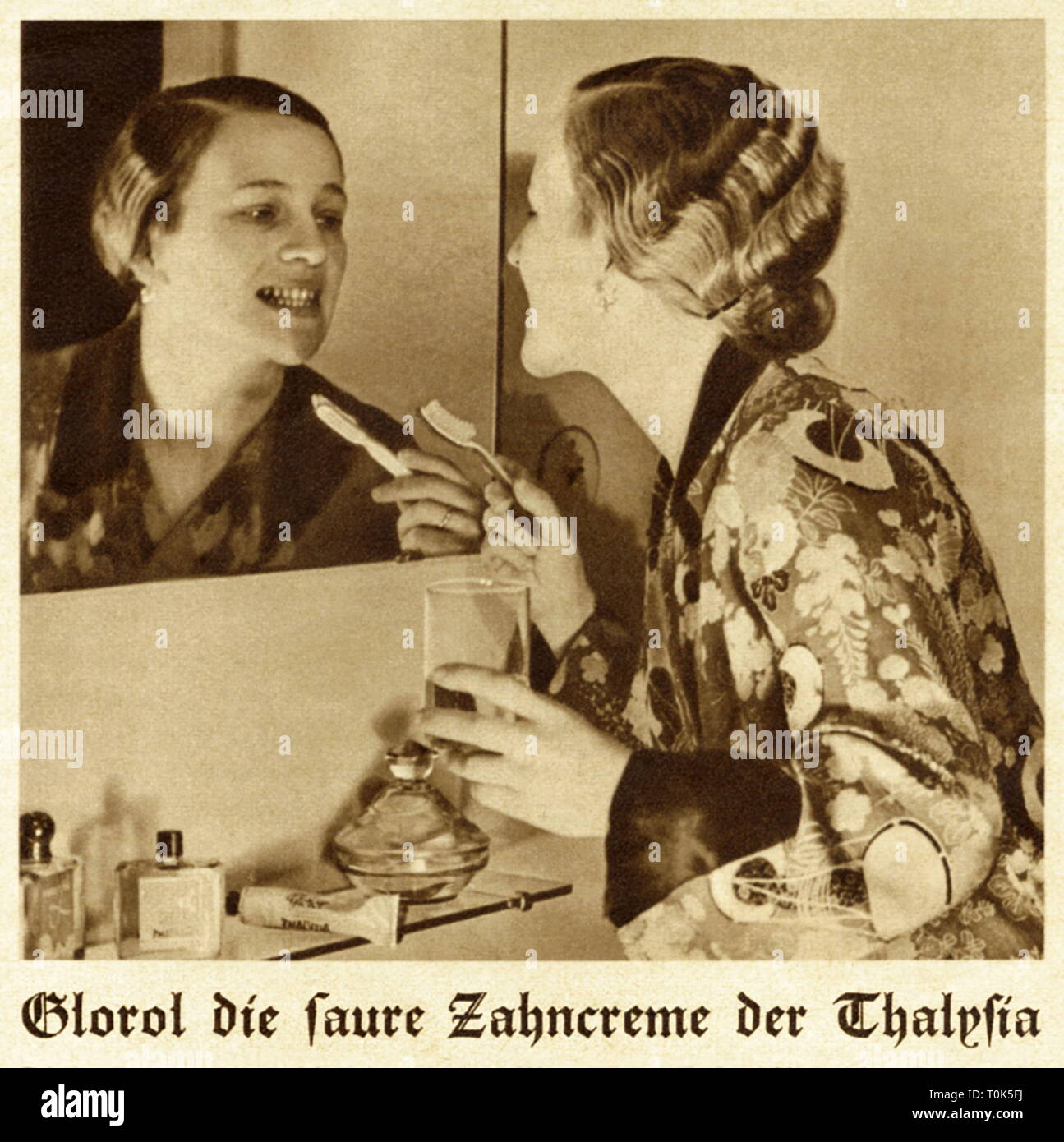 cosmetics, dental care, woman during teeth brushing, with toothpaste Glorol, citrus fresh toothpaste of the company Thalysia Paul Garms Kommandit-Gesellschaft, Reformwaren-Werk, Leipzig, Germany, circa 1935, Additional-Rights-Clearance-Info-Not-Available Stock Photo