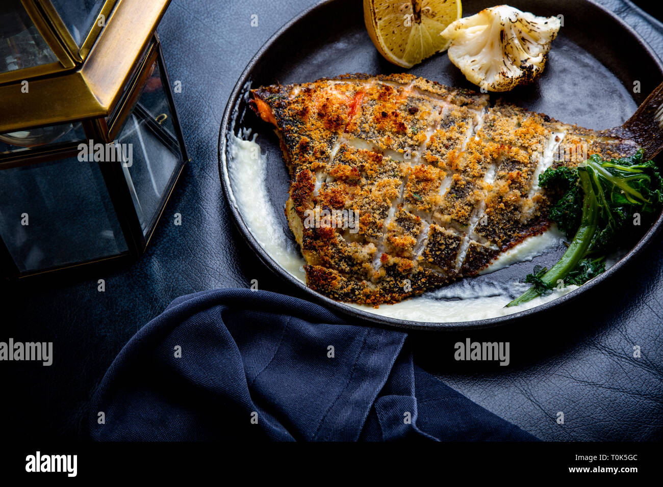 Flounder fillet roasted in a skillet with herbs and lemon Stock Photo