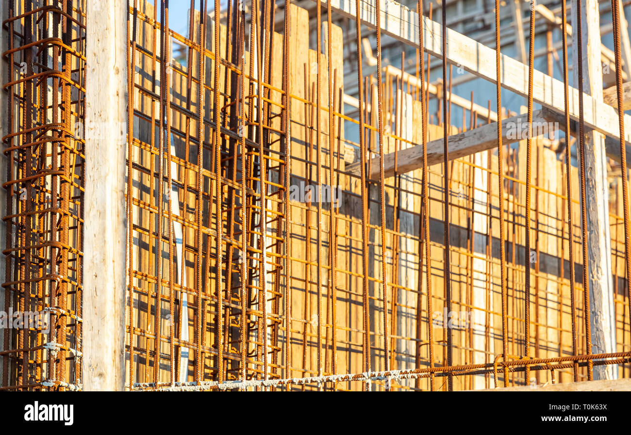 Reinforced concrete, under construction. Formworks and steel bars reinforcement in a construction site, closeup view. Stock Photo