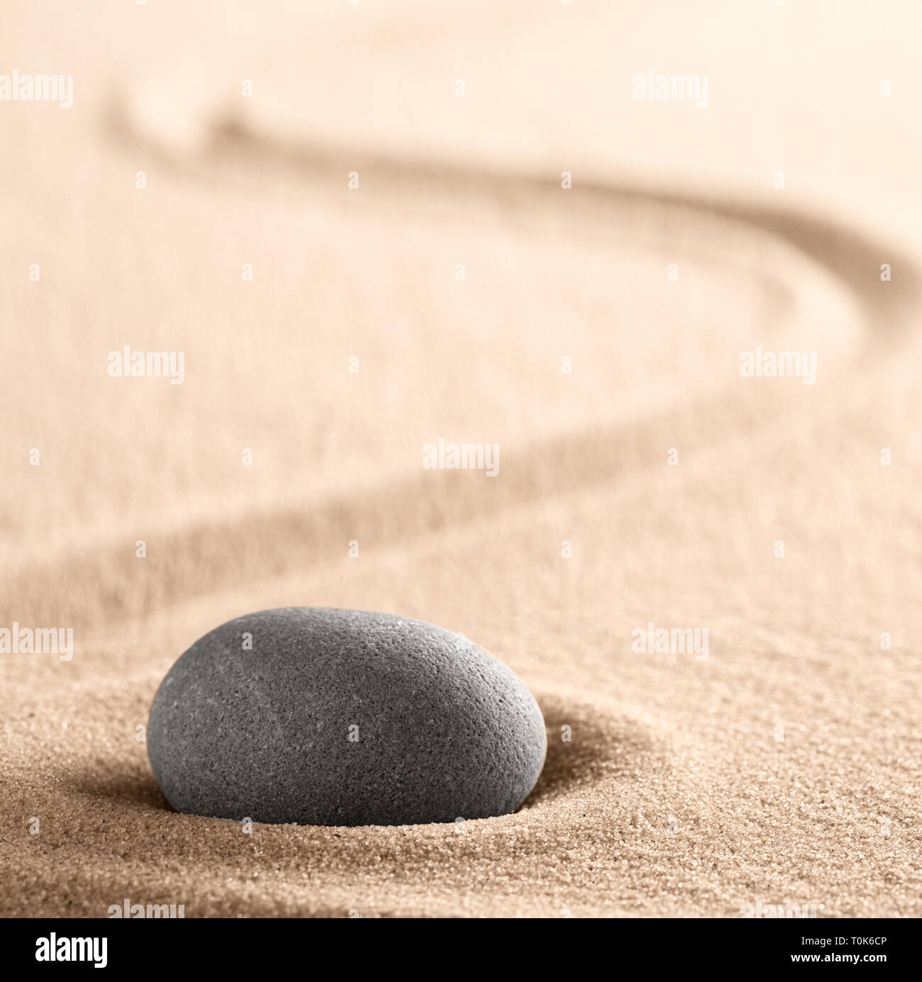 Zen meditation Japanese stone and sand garden with raked line. Concept for concentration and focus for purity, harmony and balance. Background with co Stock Photo