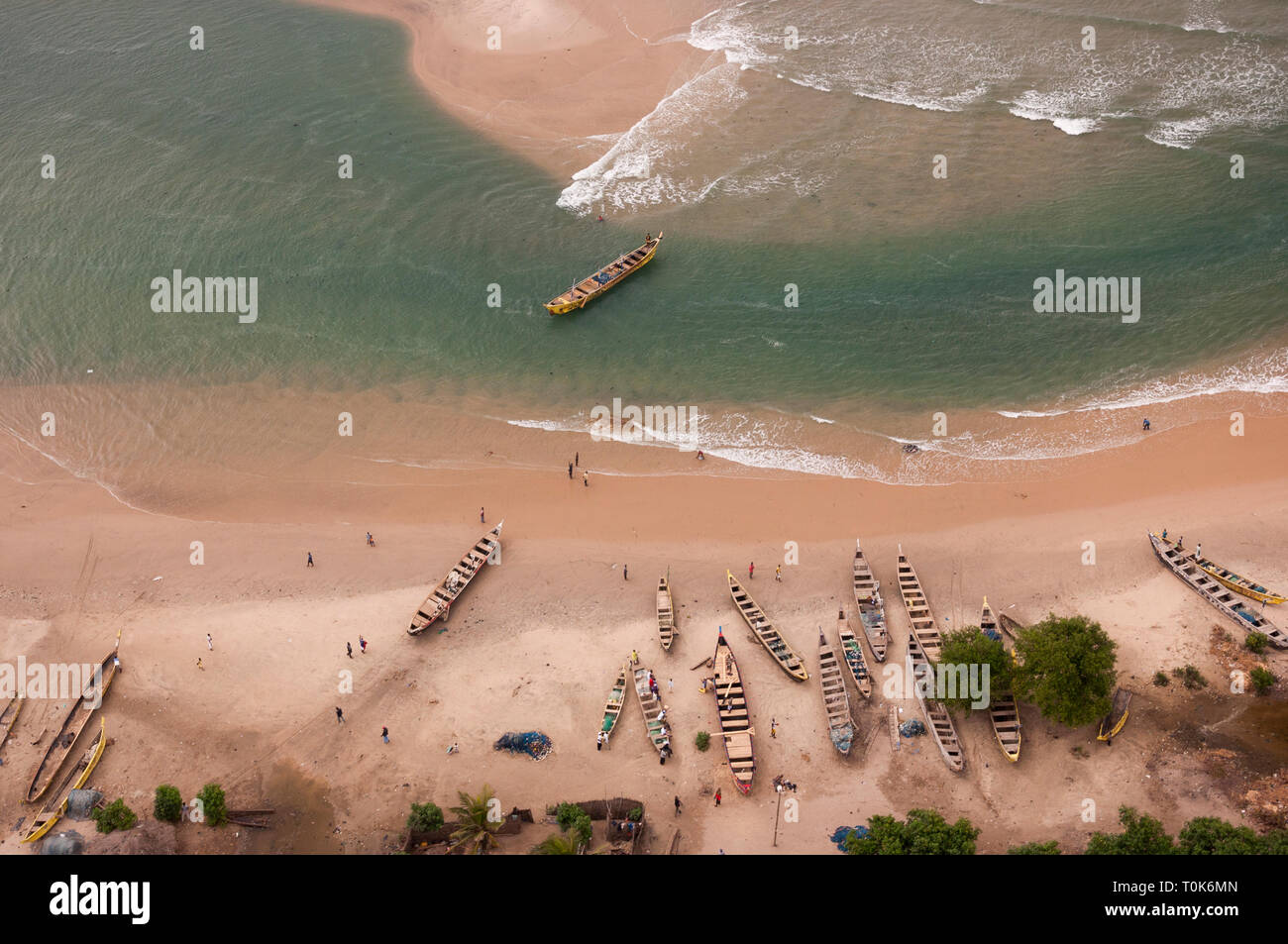 Aerial shot of Ghanaian fishermen and canoes on a beach west of Accra. Stock Photo