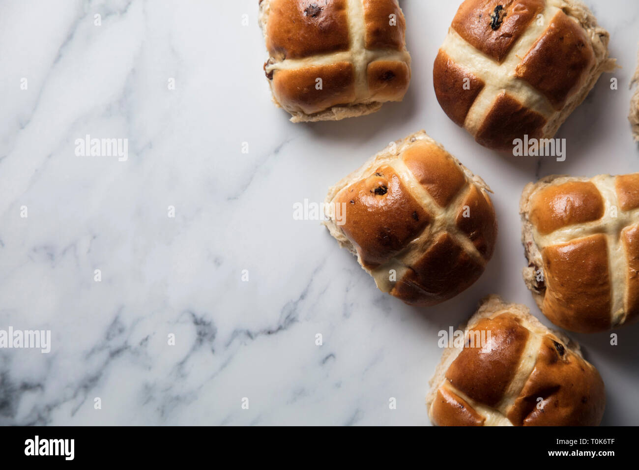 Traditional hot cross buns with raisins on a marble surface Stock Photo