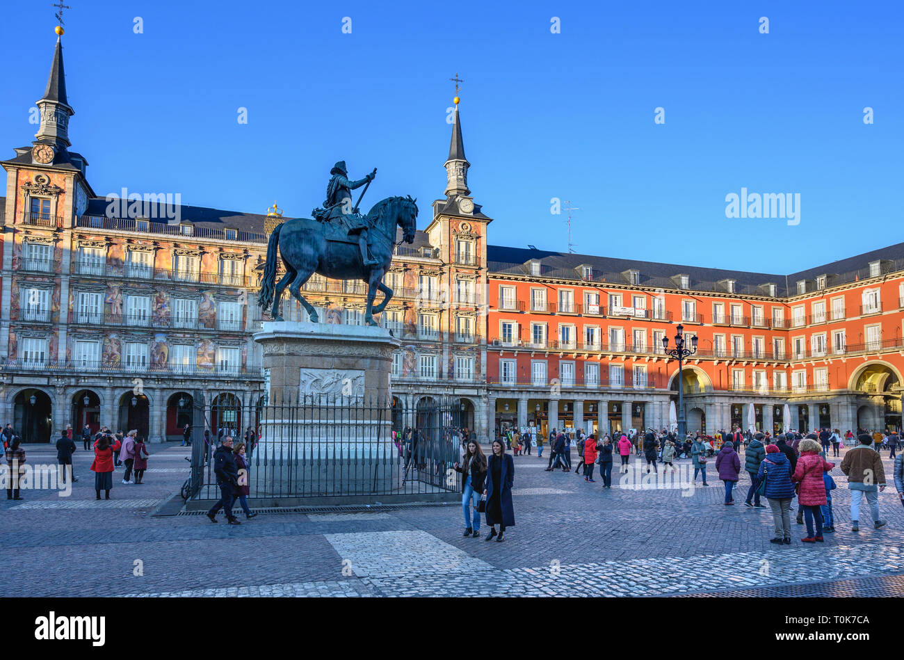 People enjoying the late afternpoon sunshine in the Plaza Mayor in the centre of Madrid. Spain. Stock Photo