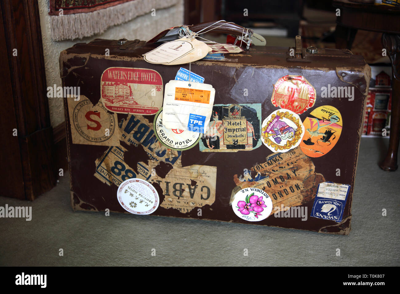 Vintage Suitcase with old Travel Stickers Stock Photo