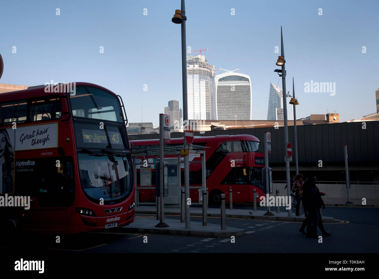 london bridge station forecourt bus stand with city of london skyscrapers in background Stock Photo