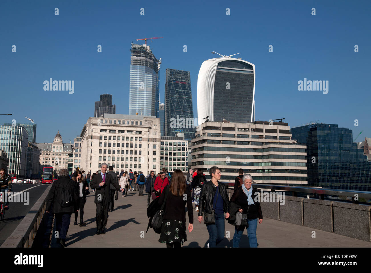 pedestrians on london bridge looking towards city of london england Stock Photo