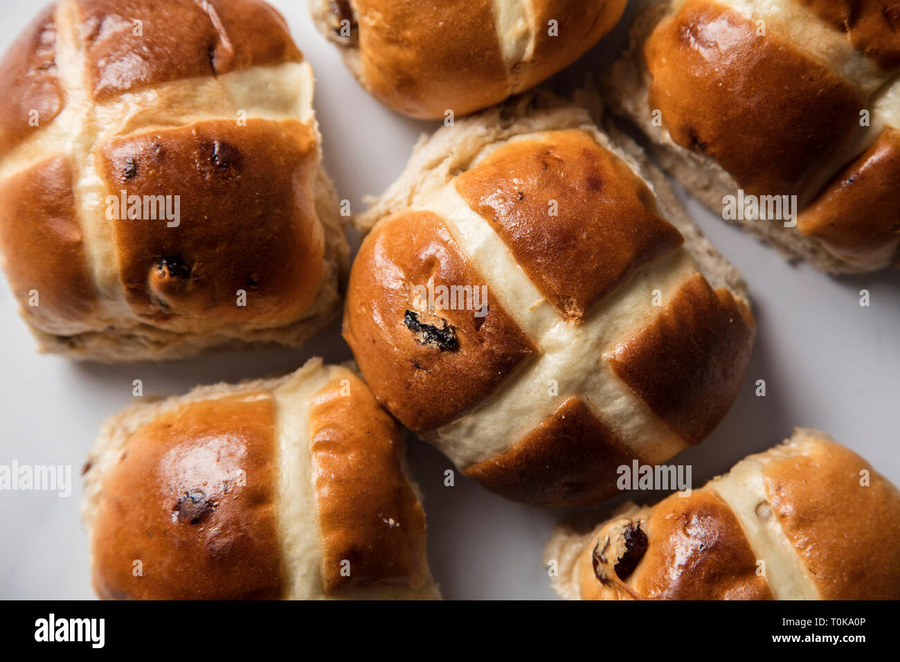 Traditional hot cross buns with raisins on a marble surface Stock Photo