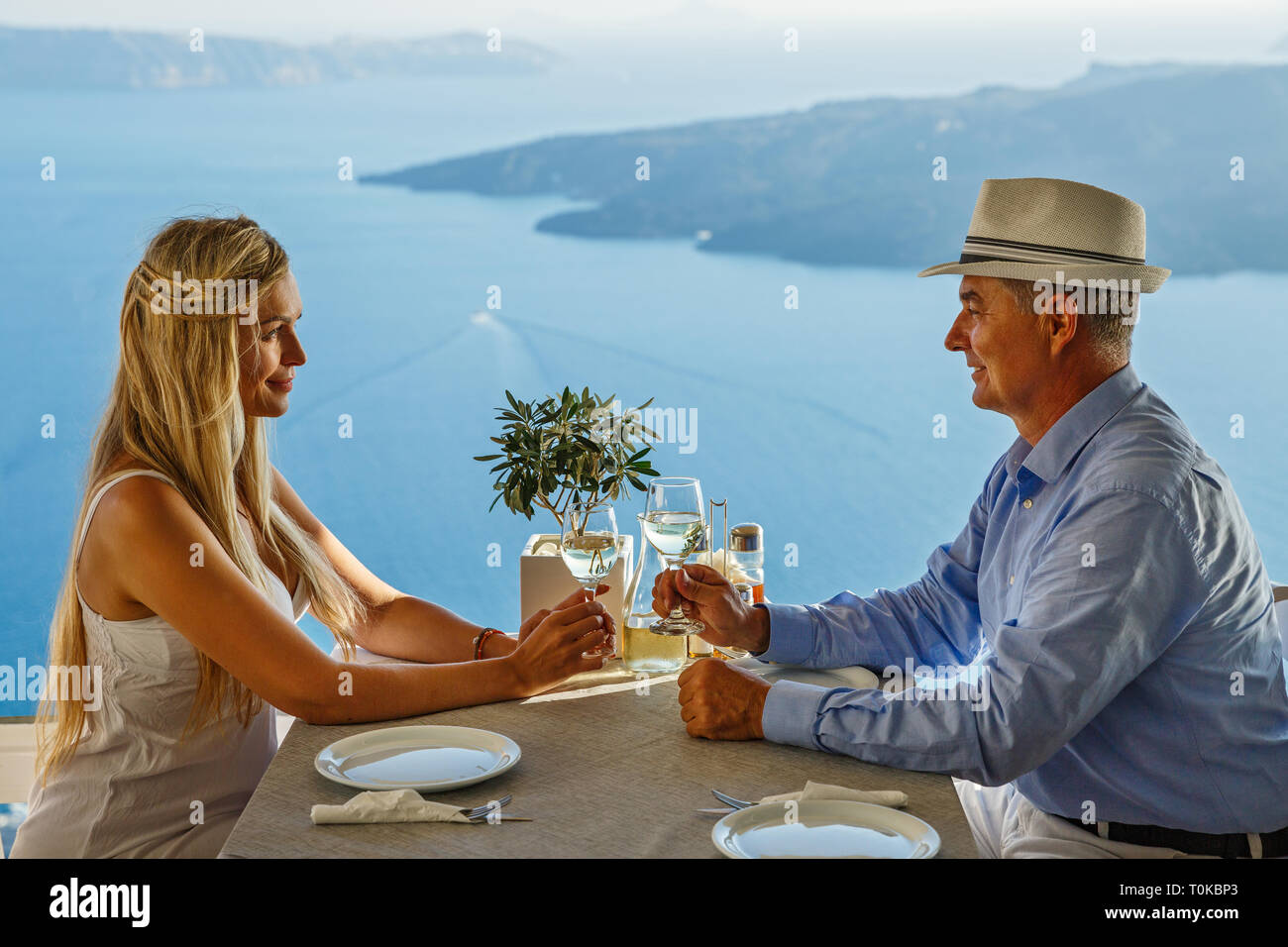 Adult couple having dinner and drinking wine in a restaurant on the background of the sea Stock Photo