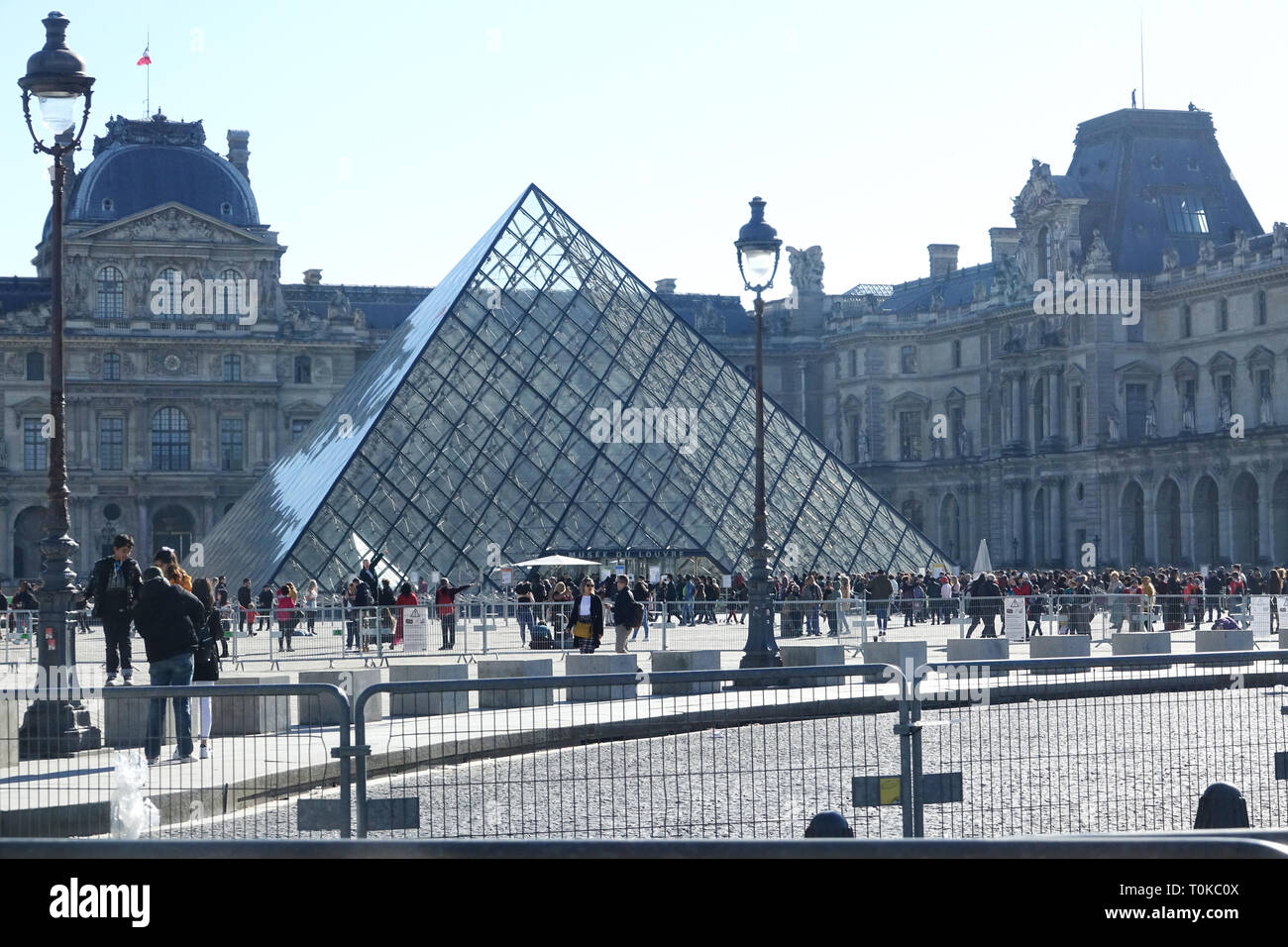 PARIS-FRANCE-FEB 25, 2019:The Louvre Pyramid is a large glass and metal pyramid designed by Chinese-American architect I.M. Pei, surrounded by three s Stock Photo