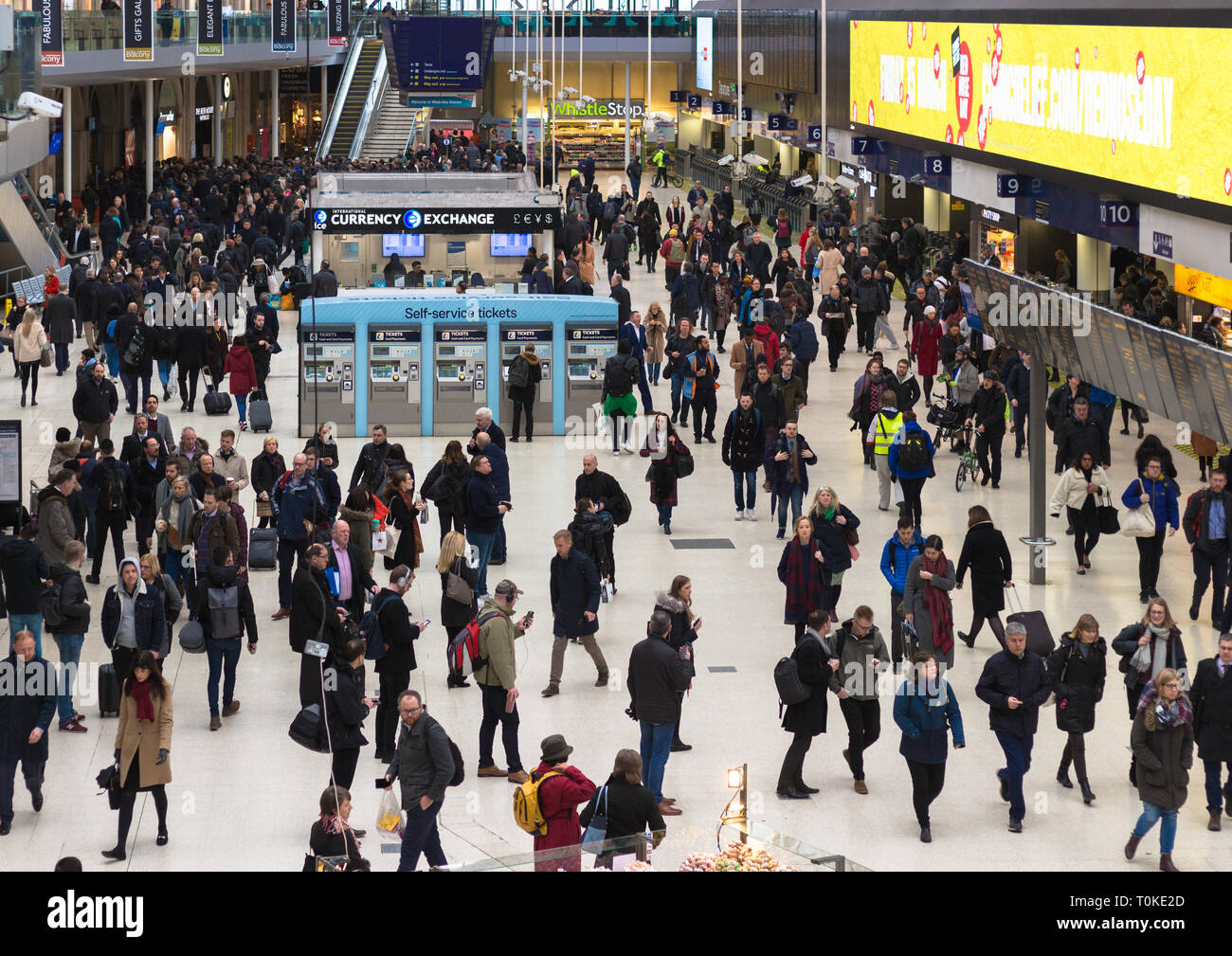 Busy concourse at London Waterloo railway station at rush hour, full of commuters and travellers making their journeys Stock Photo