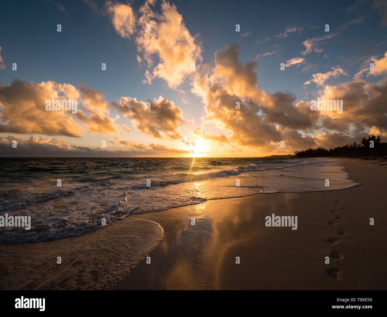 Beautiful Tropical Beach Sunset, with Footprints in the Sand, Governors Harbour, Eleuthera Island, The Bahamas, The Caribbean. Stock Photo