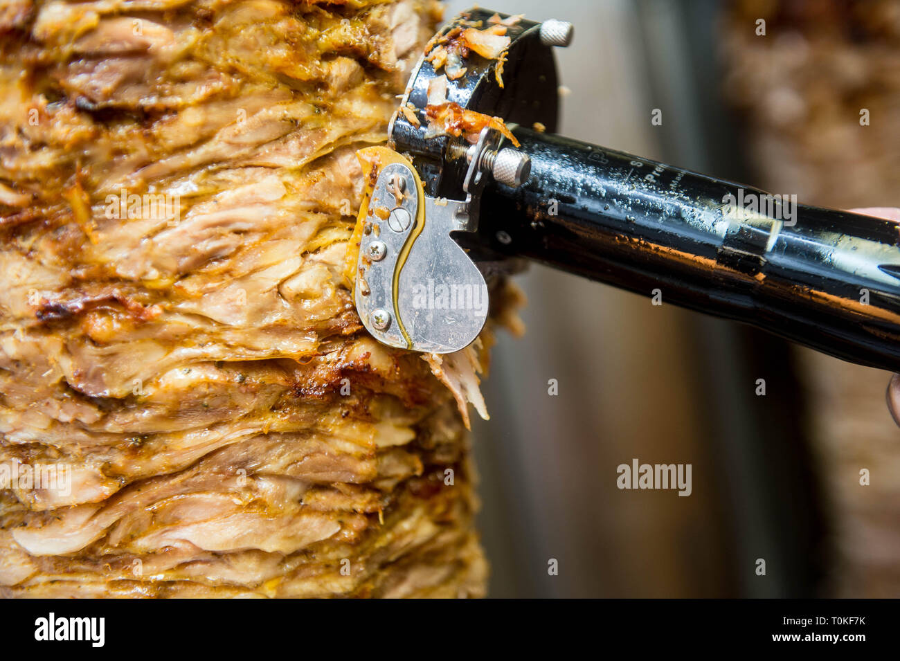 Detail of a Donner kebab meat being cut  in a Kebab shop Stock Photo