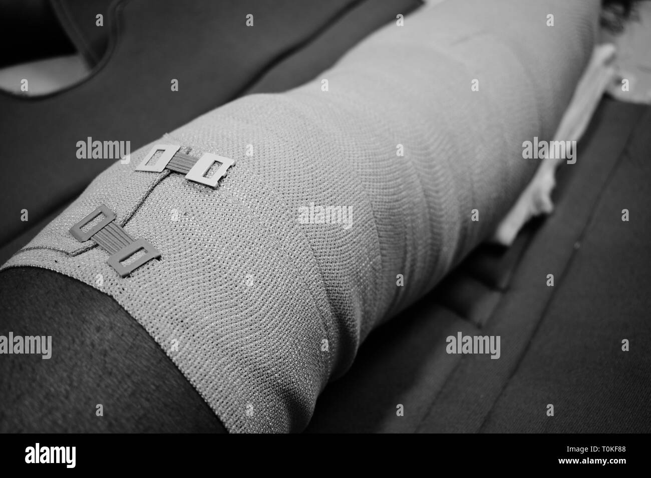 Bandage on an injured knee leg Stock Photo