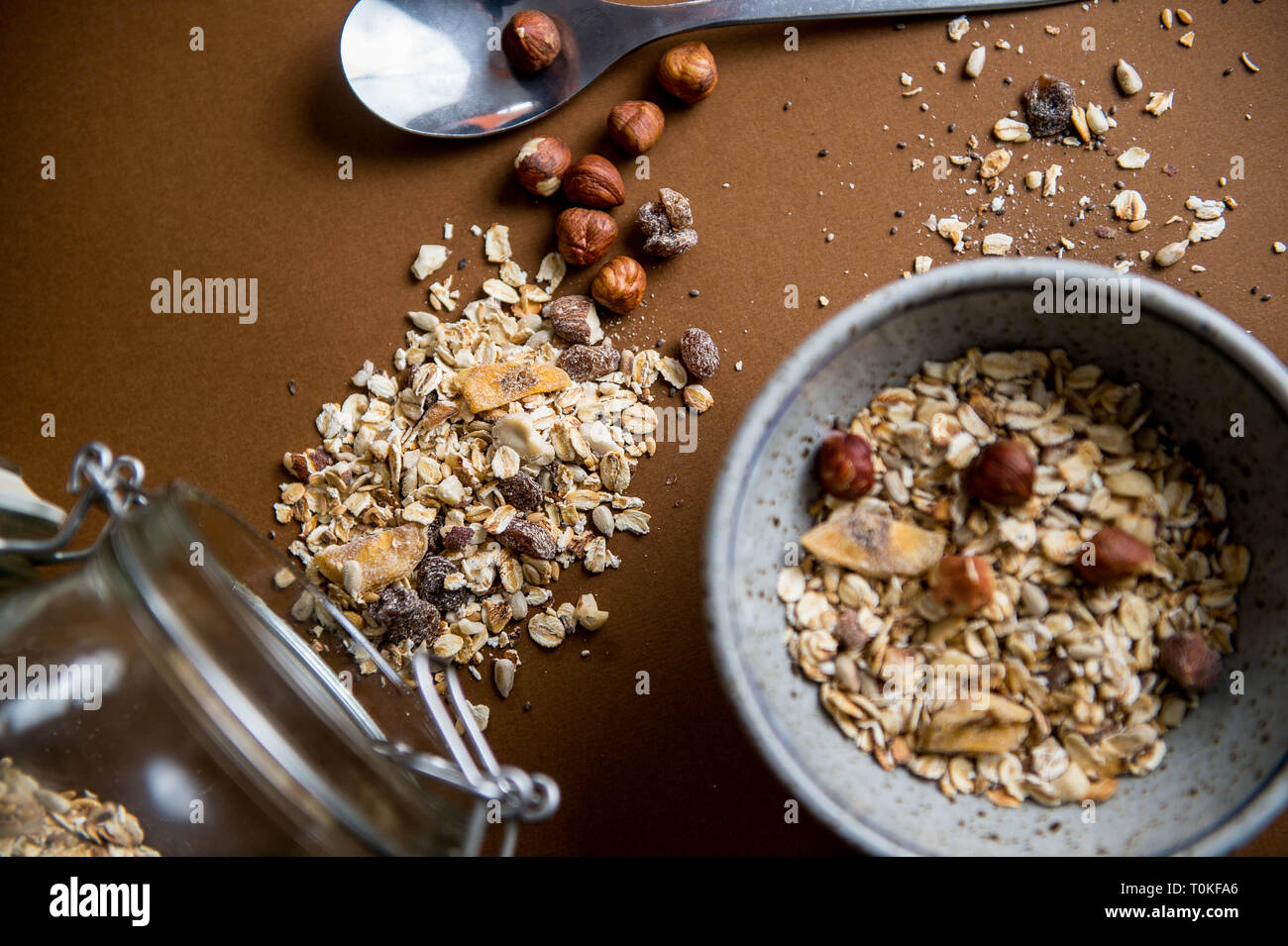 Breakfast cereal spilled on a brown backdrop Stock Photo