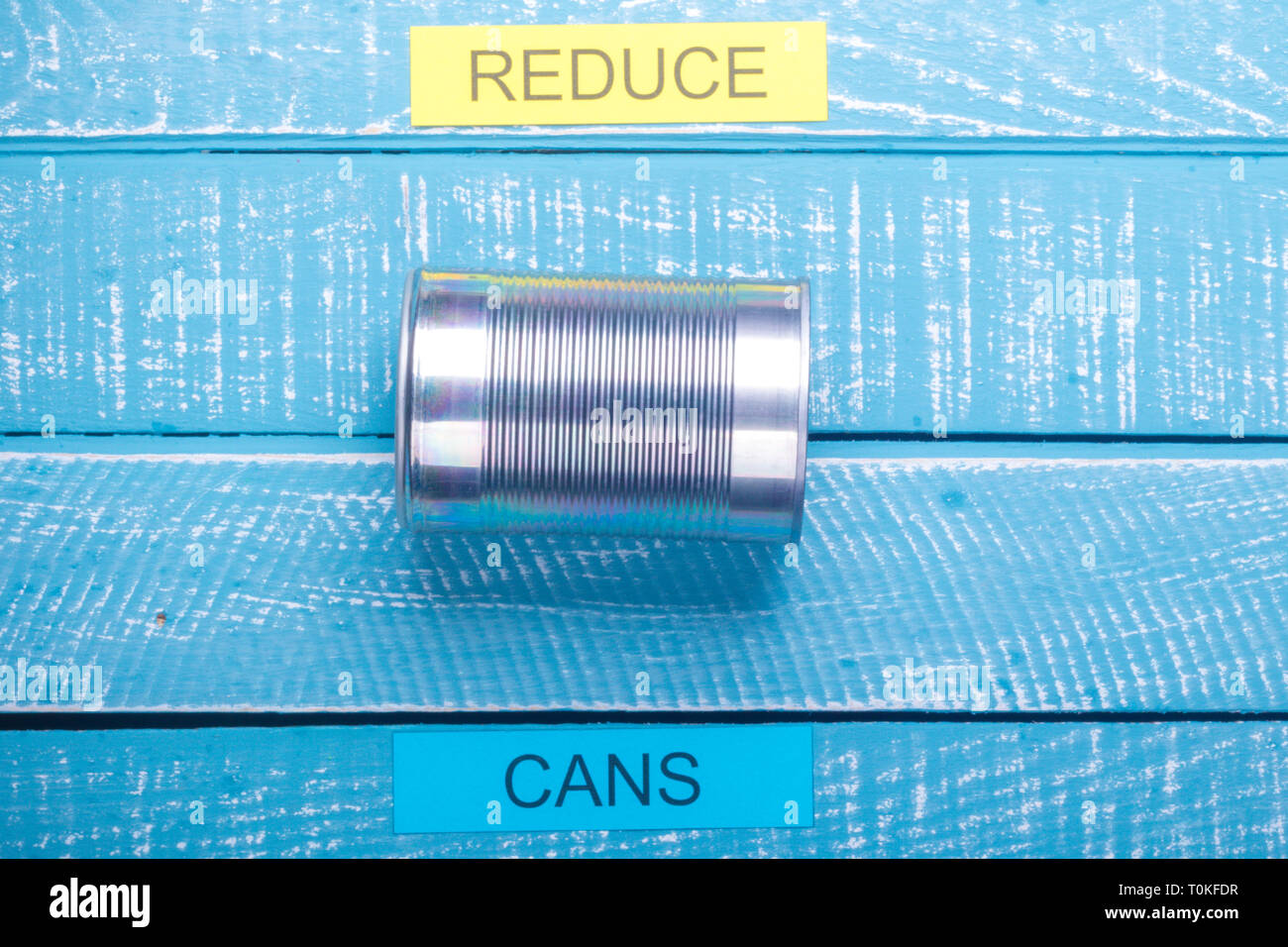 Recycle concept showing cans reduce and on a blue weathered background ...