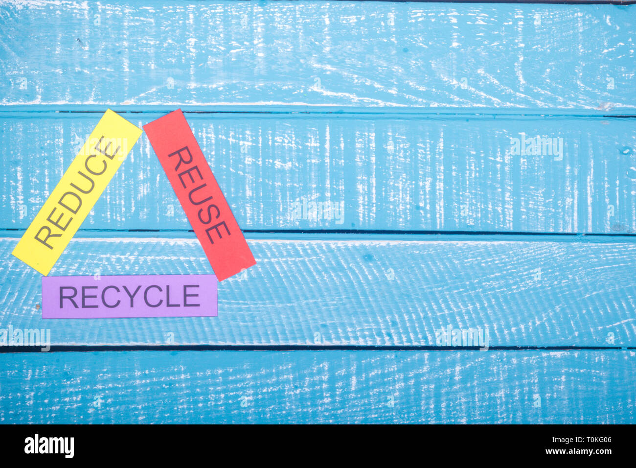 Recycle concept showing reduce, reuse & recycle on a blue weathered ...