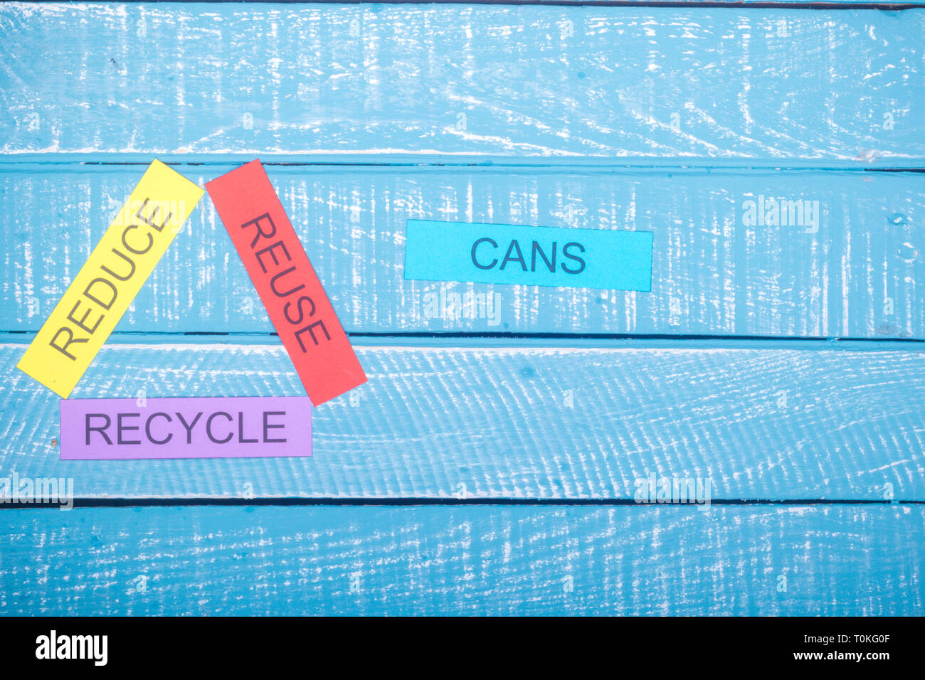 Recycle concept showing reduce, reuse & recycle on a blue weathered ...