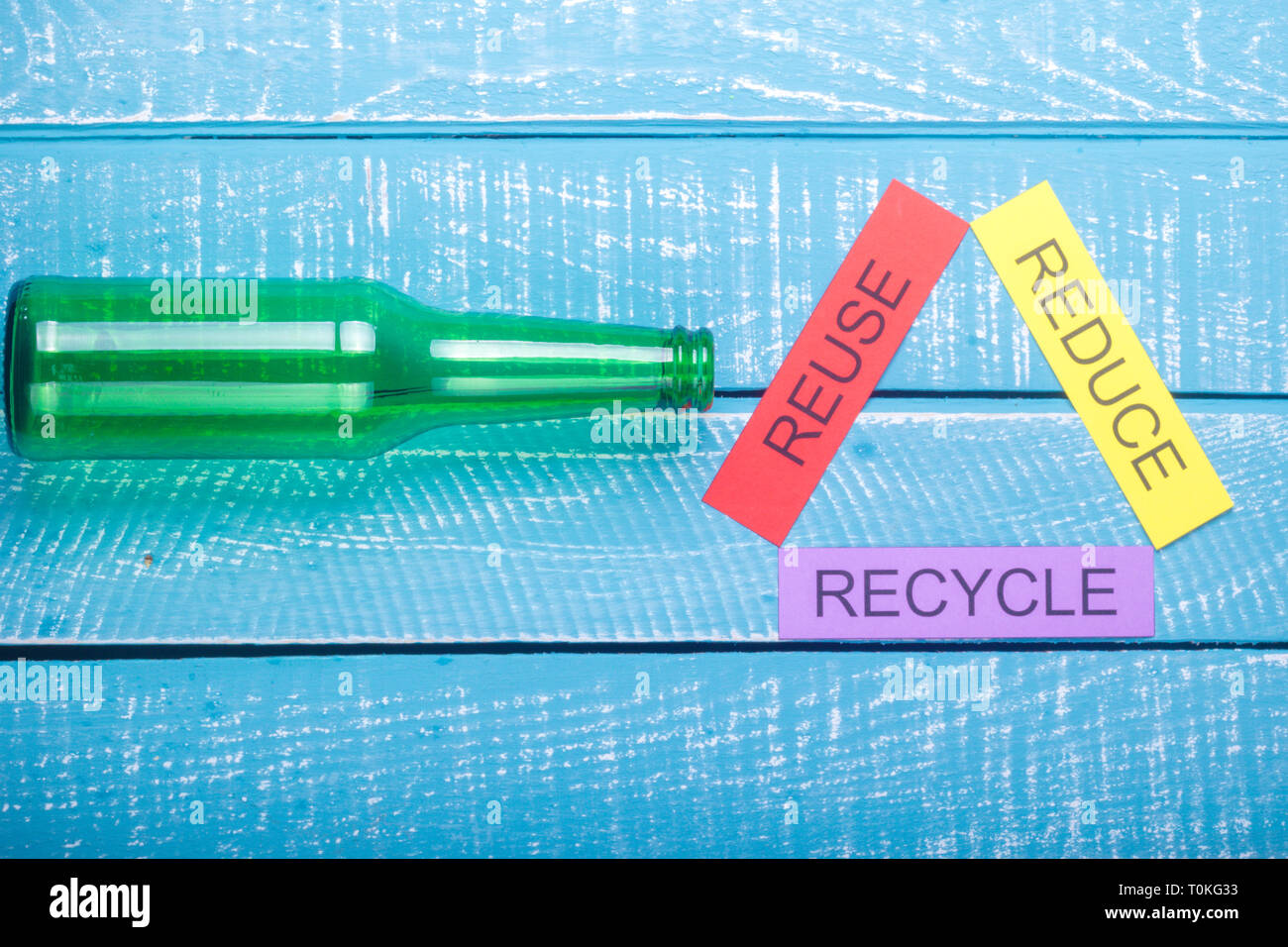 Recycle concept showing reduce, reuse, recycle with glass on a blue ...