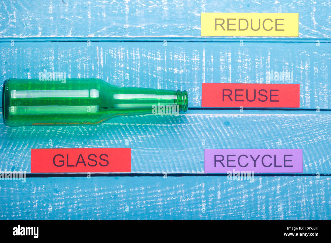 Recycle concept showing reduce, reuse, recycle with glass on a blue ...