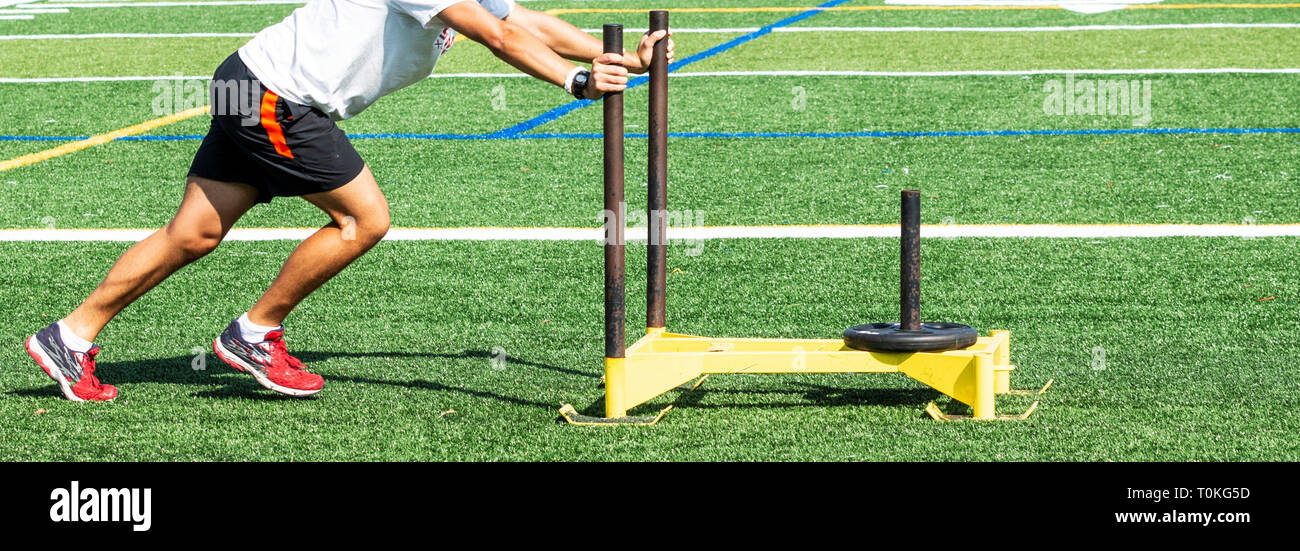 Football Player Pushing Sled