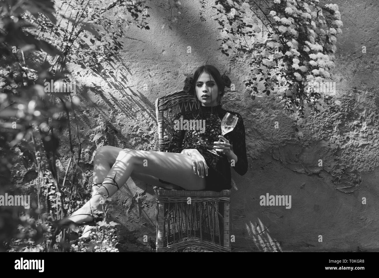 woman with closed eyes and glass sitting on chair Stock Photo - Alamy