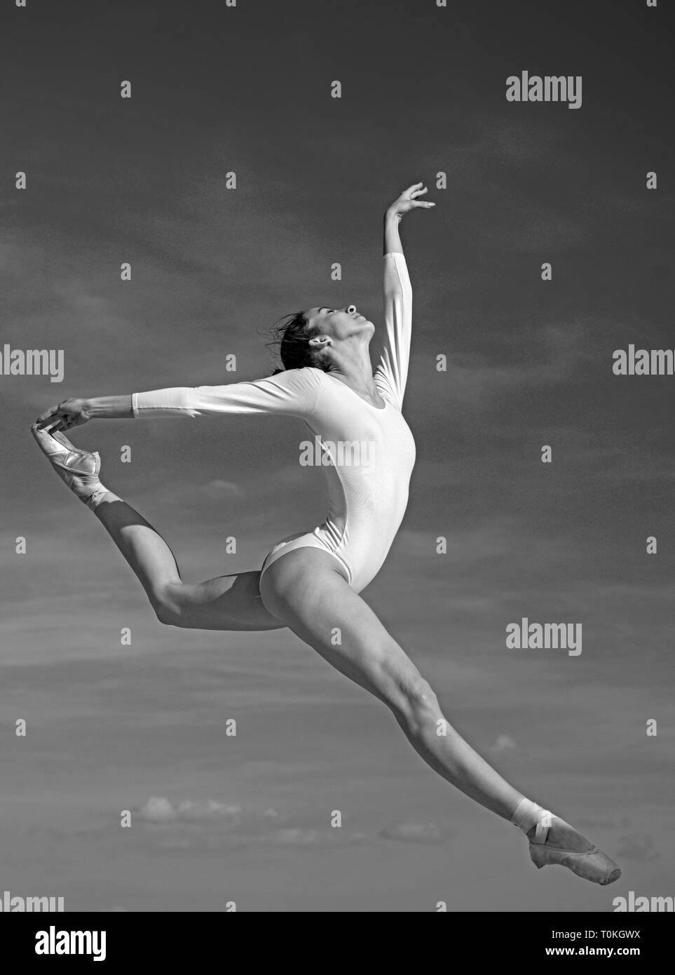 Graceful beauty. Concert performance dance. Young ballerina jumping on blue sky. Classic dance style. Cute ballet dancer. Pretty woman in dance wear Stock Photo