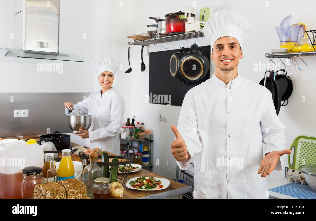 Work About Cook Friendly happy male young cook wearing uniform working on kitchen Stock ...