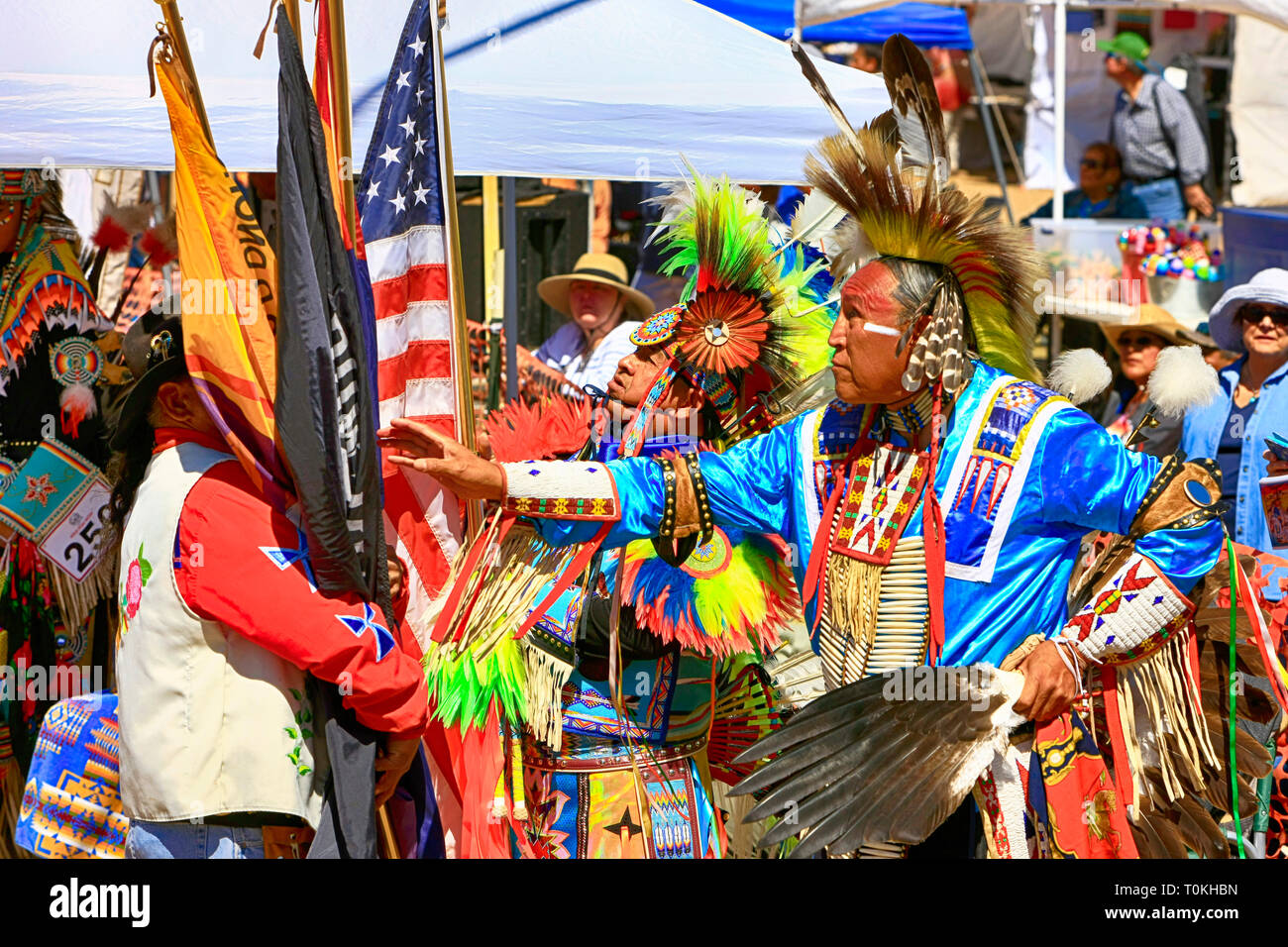 Male Native America warriors holding the US Flag wearing ceremonial ...