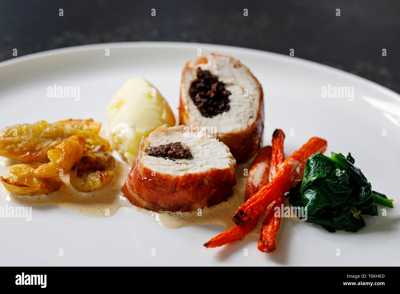 Chicken balmoral stuffed with black pudding, carrots, spinach and