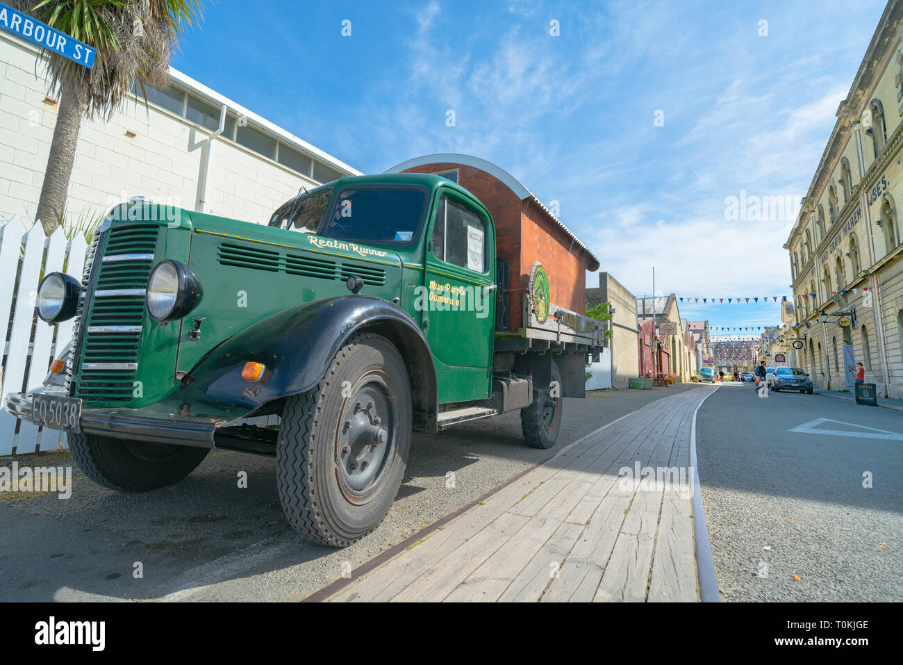 OAMARU NEW ZEALAND - OCTOBER 24 2018; Vintage green Bedford truck Miss Purple or Realm Runner converted to house-truck parked on side of intersection Stock Photo