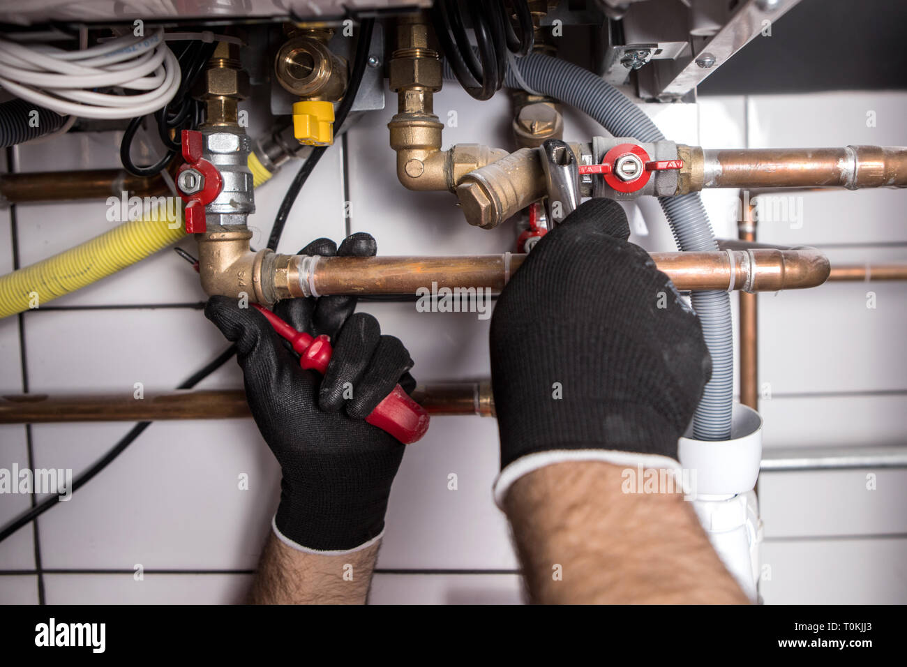 plumber fixing central heating system Stock Photo Alamy