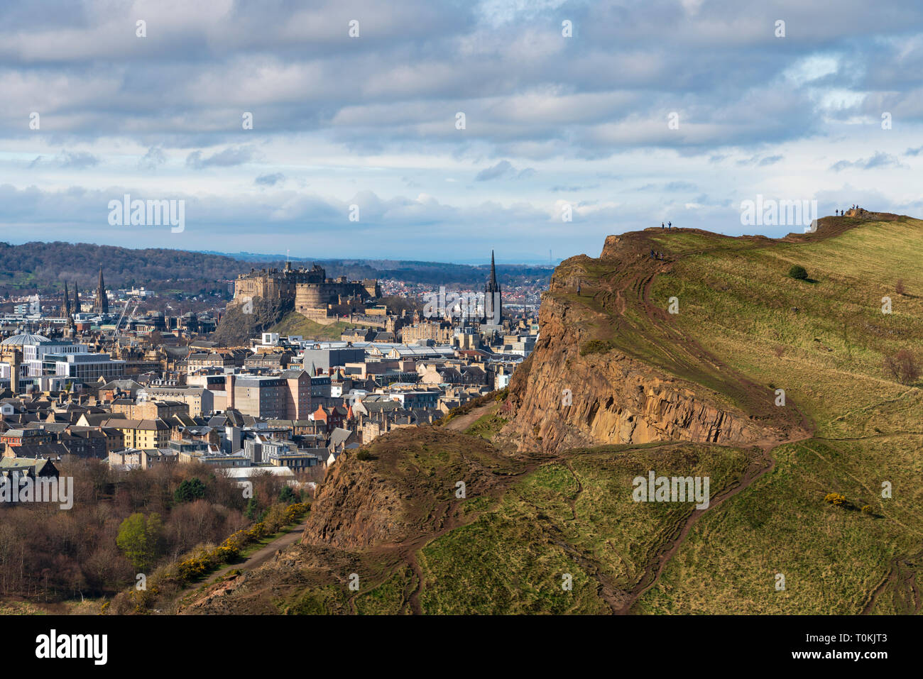 View of city of Edinburgh over Salisbury Crags from Arthur's Seat , Edinburgh, Scotland, UK. Stock Photo