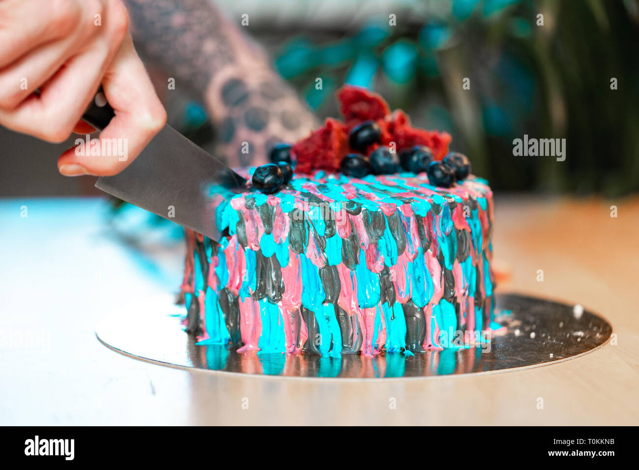 Close Up Of Tattooed Man Cutting Cake With Colourful Cream Juicy Filling With Red Berries Stock Photo Alamy Close Up Of Tattooed Man Cutting Cake With Colourful Cream Juicy Filling With Red Berries Stock Photo Alamy