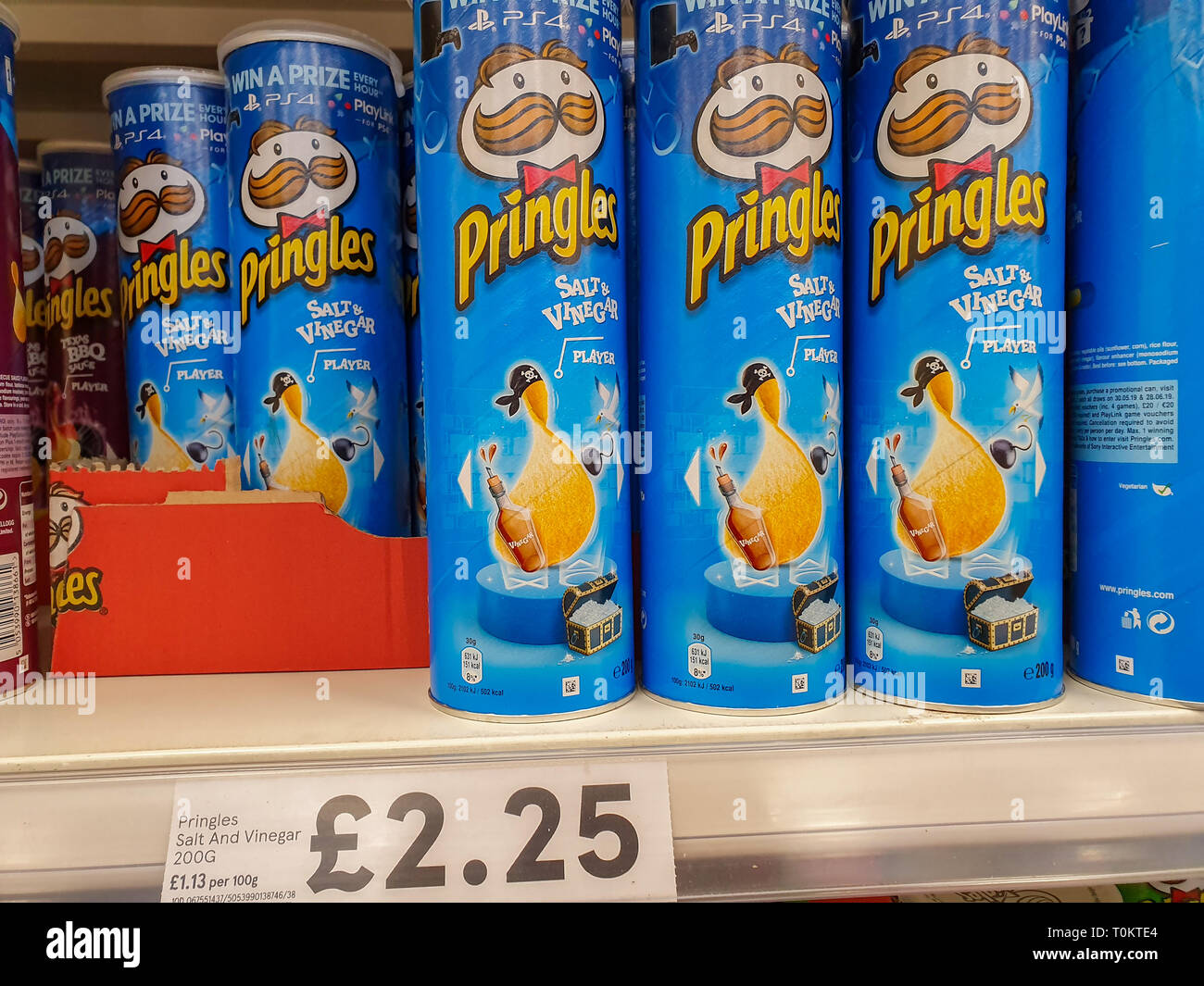 SHEFFIELD, UK - 20TH MARCH 2019: Tubs of salt and vingegar Pringles sit on a shefl Stock Photo