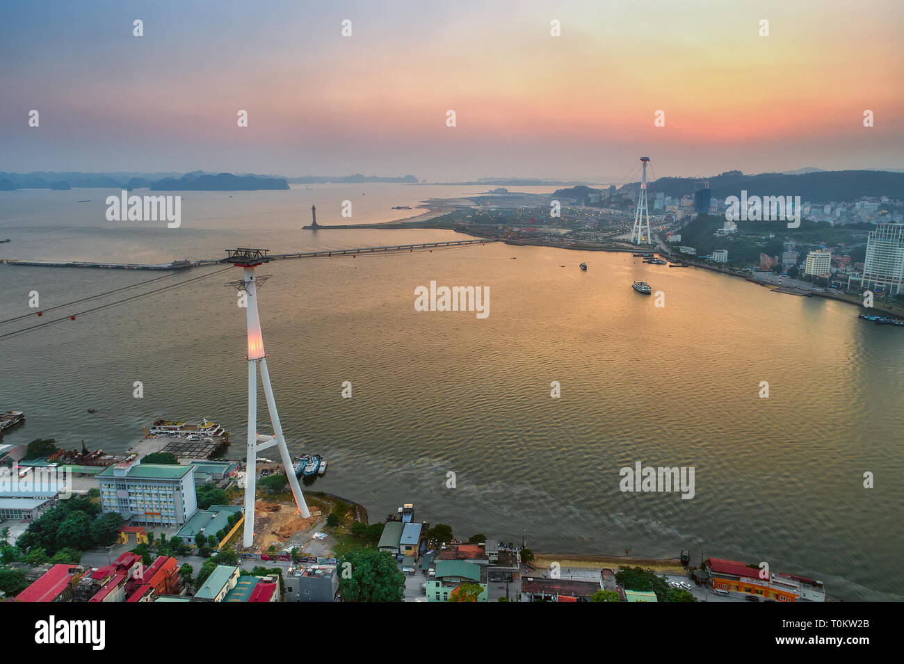 Top view aerial photo from flying drone of Ha Long City with development buildings, transportation, ferris wheel, aerial cable or telepheric. Vietnam Stock Photo