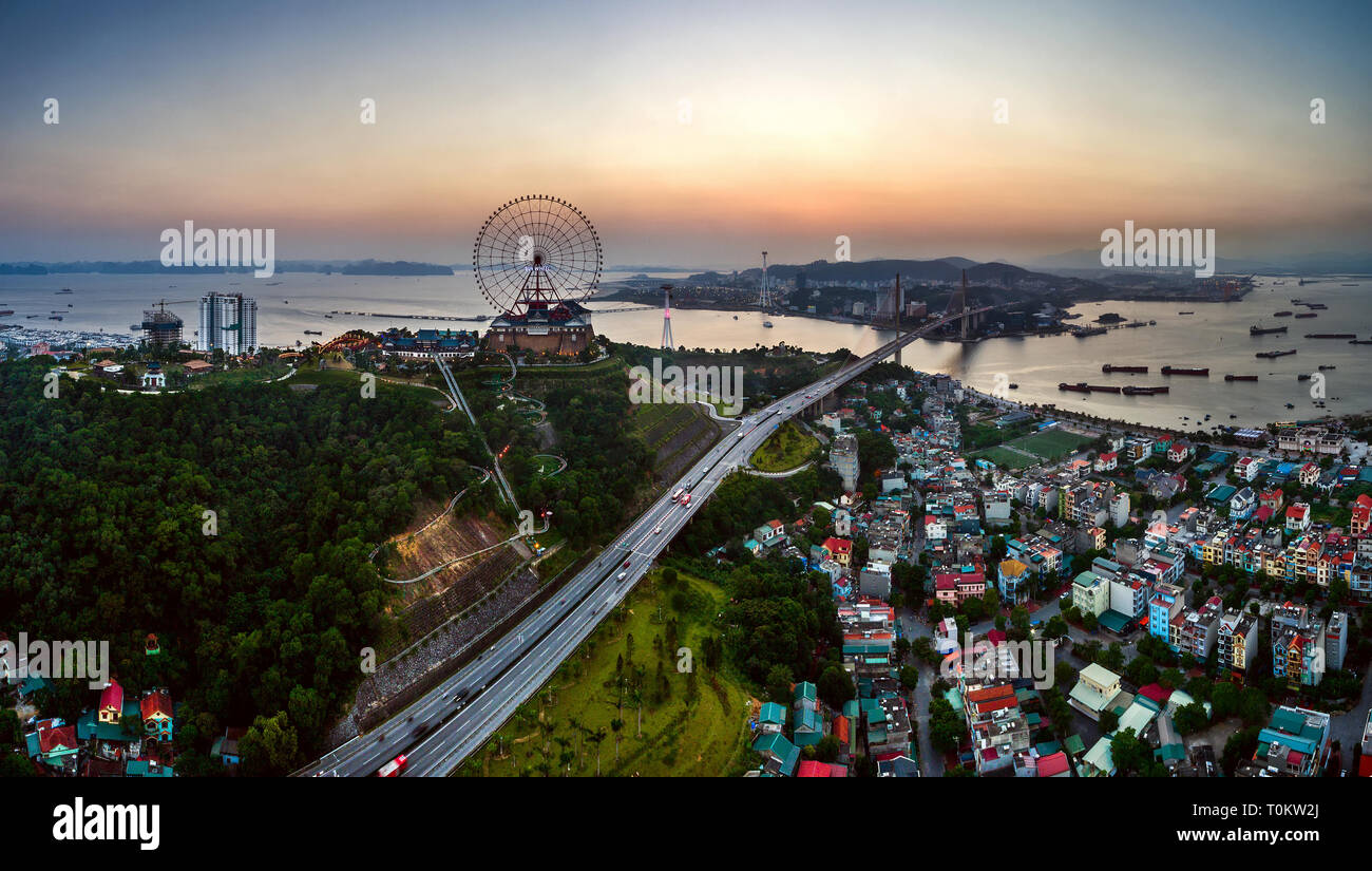 Top view aerial photo from flying drone of Ha Long City with development buildings, transportation, ferris wheel, aerial cable or telepheric. Vietnam Stock Photo