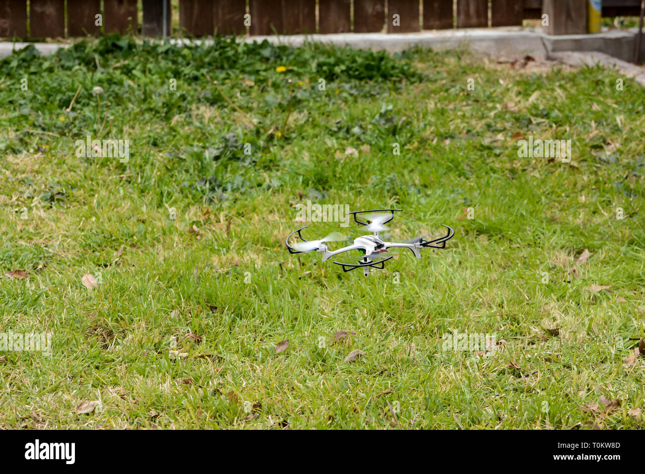 A camera drone flying low to the ground in a backyard Stock Photo Alamy