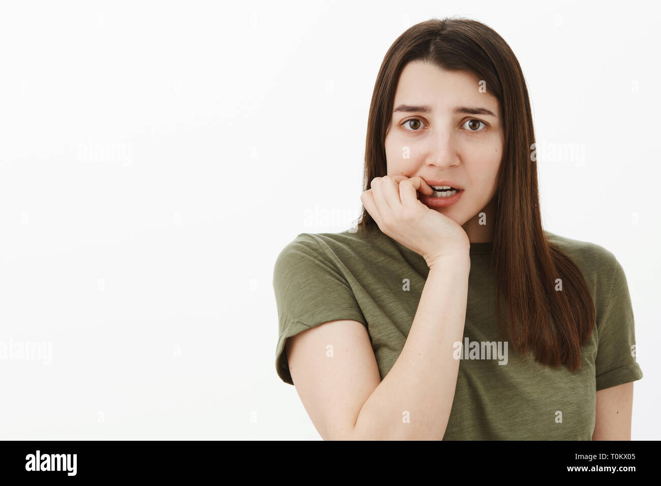 Closeup shot of nervous unsure and insecure female coworker messing up
