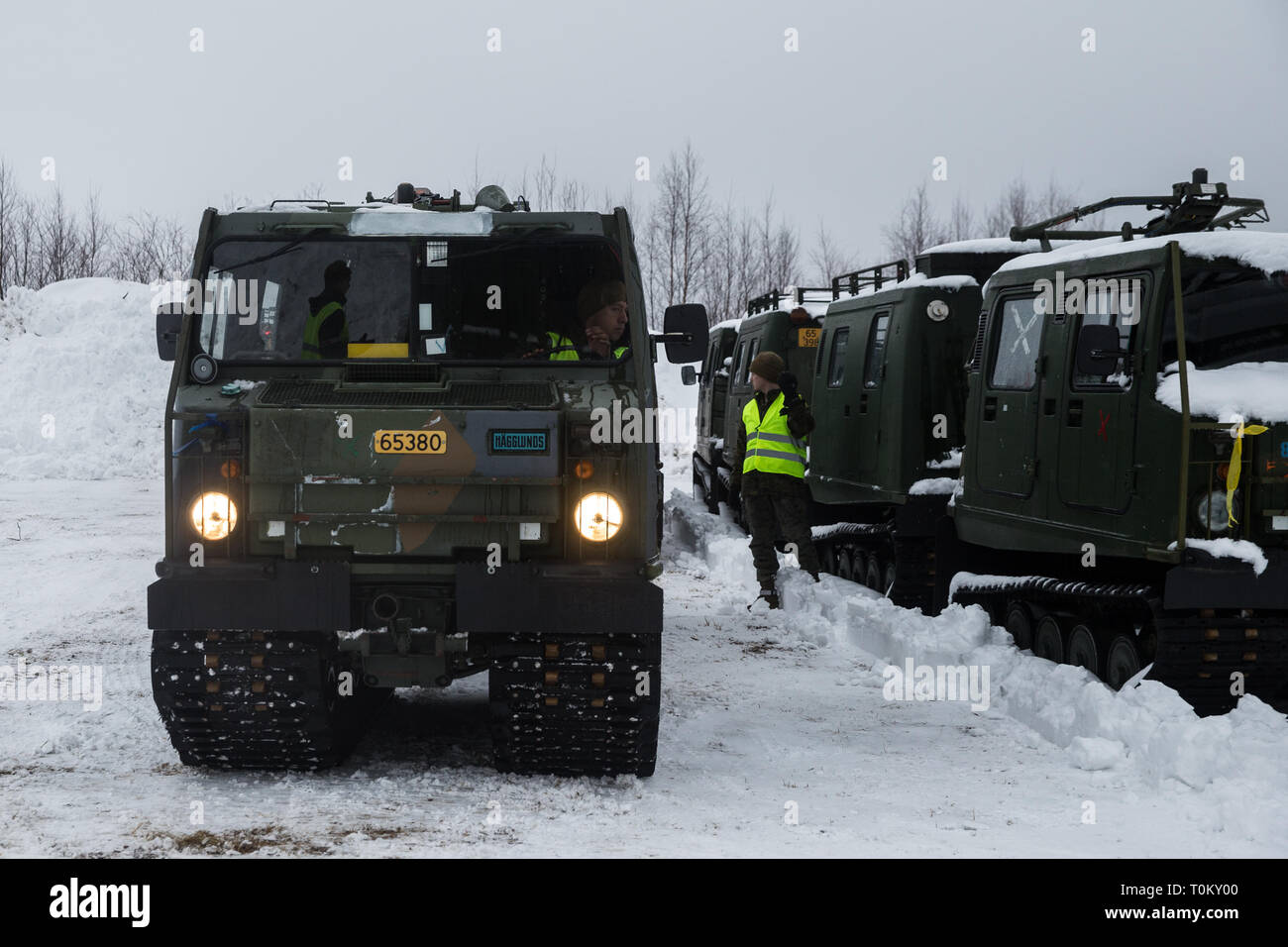 A U.S. Marine with Marine Rotational Force-Europe 19.1, Marine Forces Europe and Africa, ground guides a Bandvagn 206 in preparation for Exercise Northern Wind in northern Sweden, March 15, 2019. The exercise enhanced MRF-E’s ability to receive, stage, and integrate forces quickly into the European theater. (U.S. Marine Corps photo by Cpl. Nghia Tran) Stock Photo