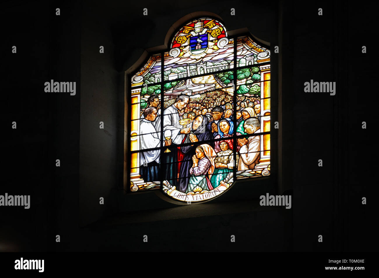 One of the stained glass windows of the basilica of Fatima representing communion in the celebrations Stock Photo