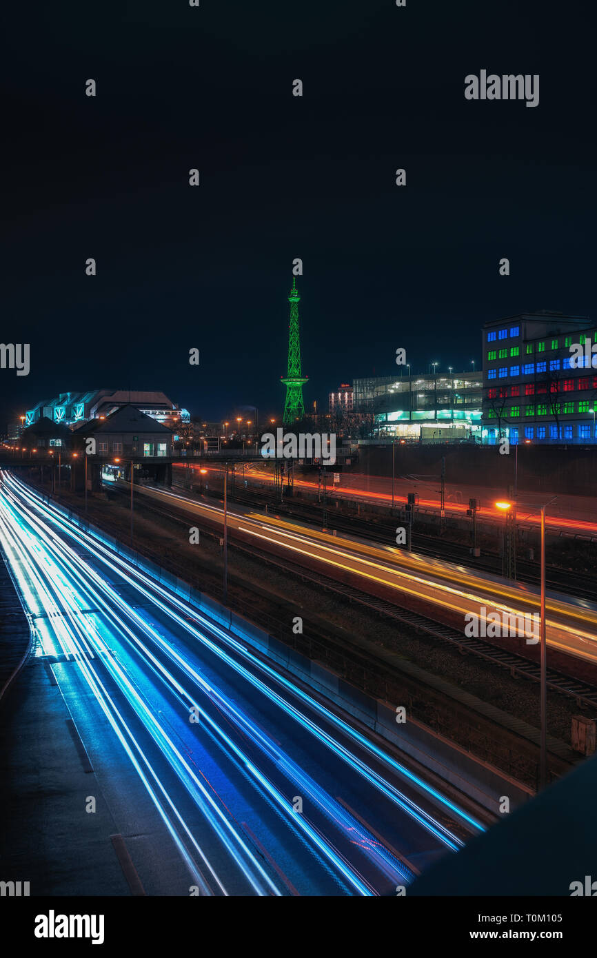 Berlin City Nightscape with traffic trails and neon lights. Stock Photo