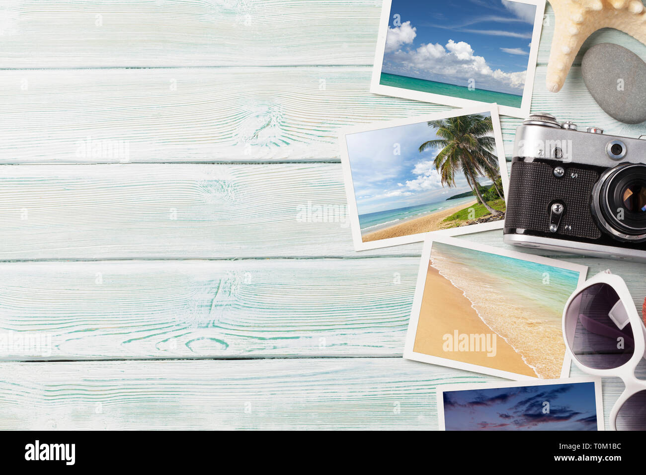 Travel vacation background concept with sunglasses, camera and weekend photos on wooden backdrop. Top view with copy space. Flat lay. All photos taken Stock Photo