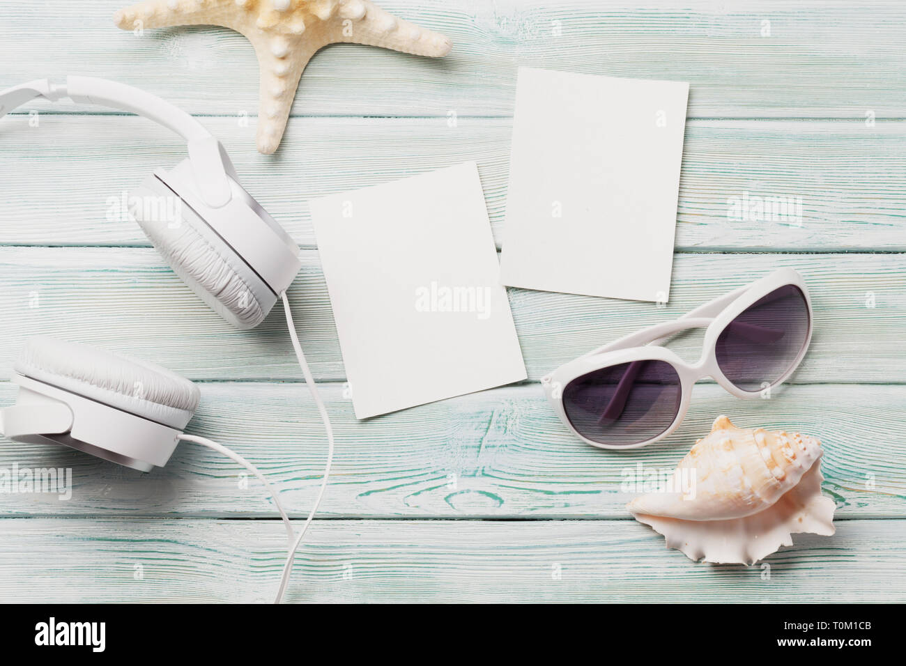 Travel vacation background concept with sunglasses, headphones and photo frames on wooden backdrop. Top view. Flat lay. All photos taken by me Stock Photo