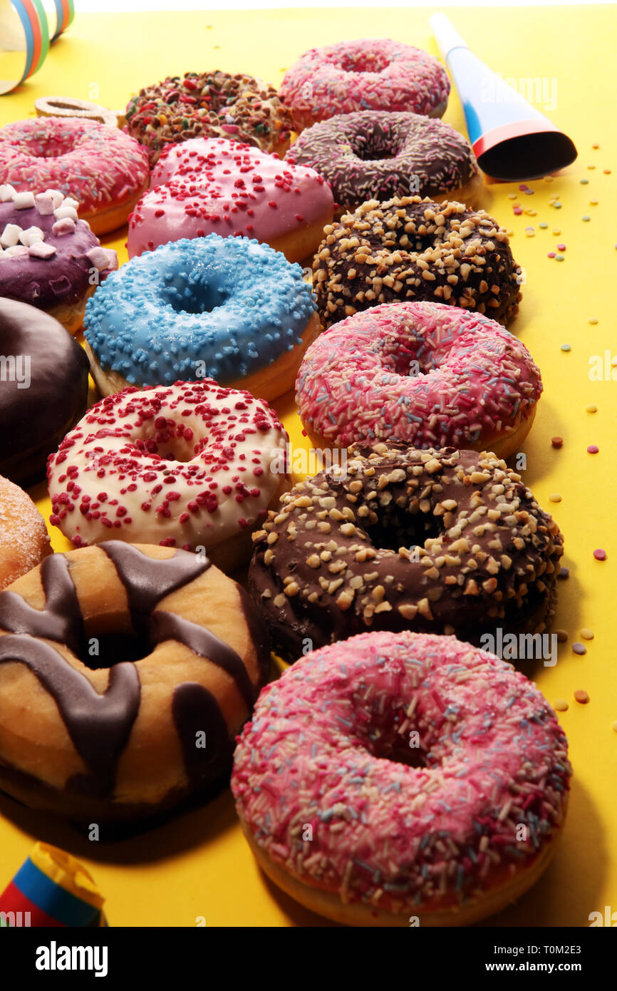 assorted donuts with chocolate frosted, pink glazed and sprinkles ...