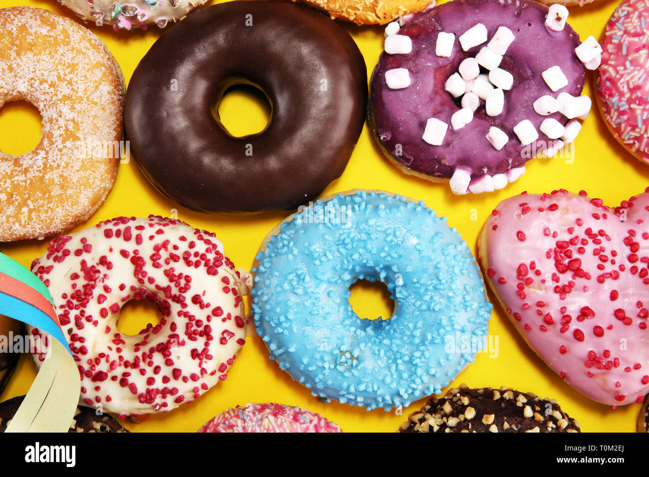 assorted donuts with chocolate frosted, pink glazed and sprinkles