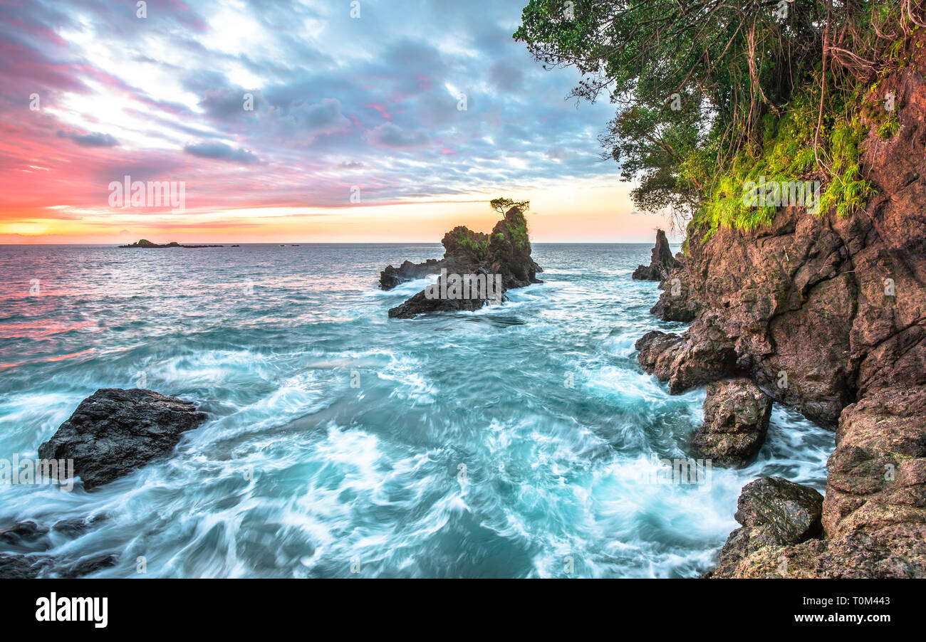 Long exposure of the sunset over the Pacific Ocean on the west side of the Osa Peninsula, Costa Rica. Stock Photo
